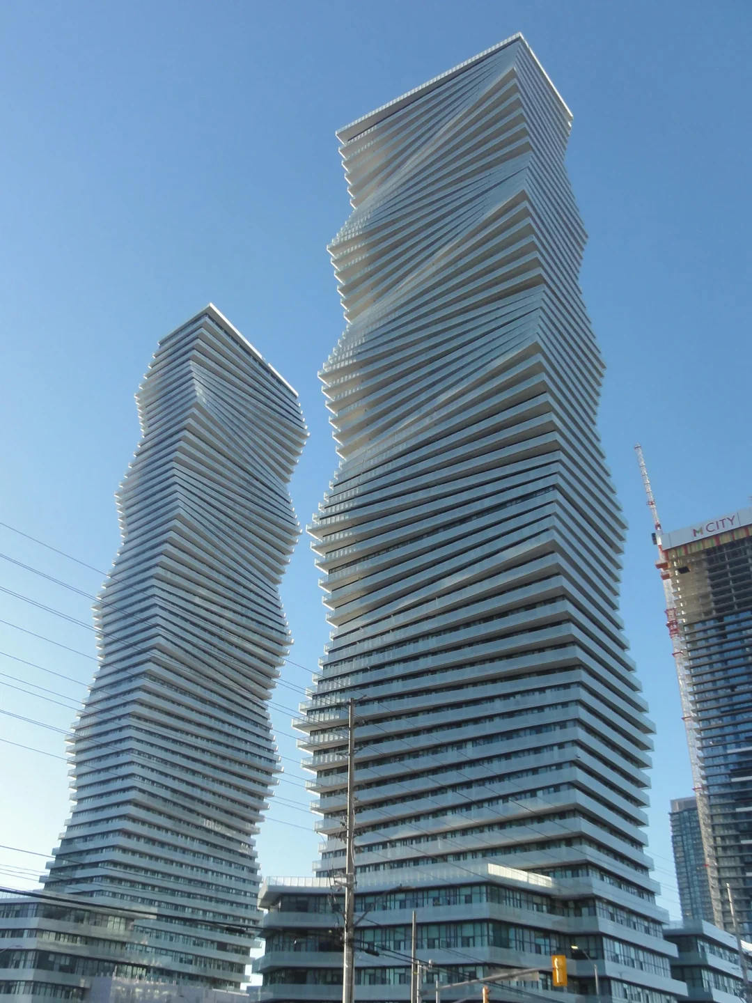 Mississauga's Absolute World towers against a blue sky